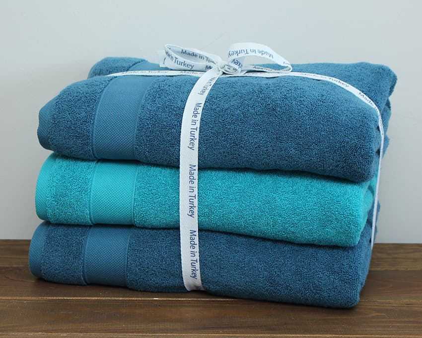 A set of towels with a plain border.